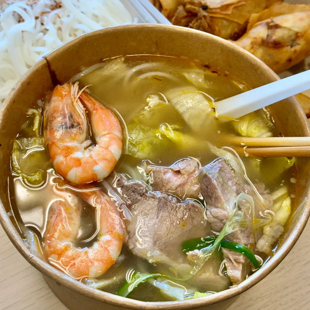 A bowl of Vietnamese noodle soup with prawns and beef